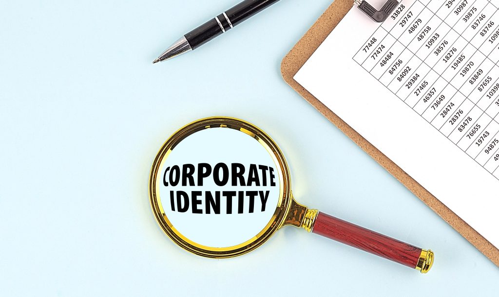 Image Description: BRAND IDENTITY text on a magnifier with clipboard on blue background